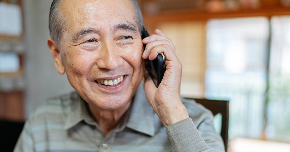 A smiling man on the phone